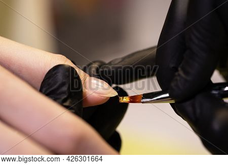 Coating Of Gel Polish On Nails With  Combined Manicure. Stage Of Work With Nail Base Coat