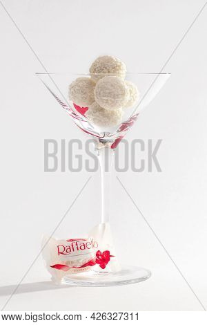 Round Rafaello Sweets In Coconut Shavings In A Glass Vase On A White Background, Harmony Of Taste, E