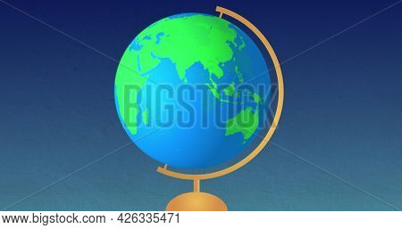 Image of green and blue globe spinning on wooden stand on blue gradient background. Back to school education concept digitally generated image.