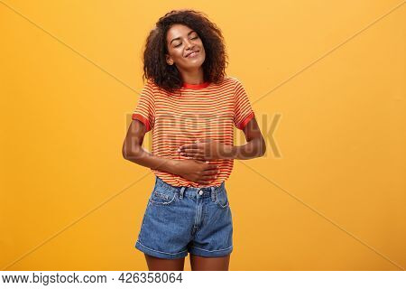 Mmm Delicious Meal Warming Me Inside. Delighted Stuffed Good-looking Stylish Young Female In Striped