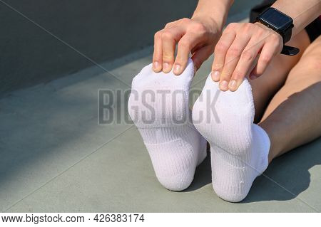 Close Up Of Runner Woman Trying To Do Foot Stretching For Prevent Injuries. The Benifit Of Stretchin