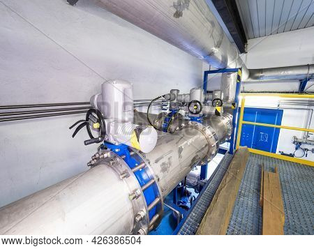 Shiny Chrome Steel Pipes, Remote Controlled Servo Valves And Blue Flanges. Technical Room Of Chemica