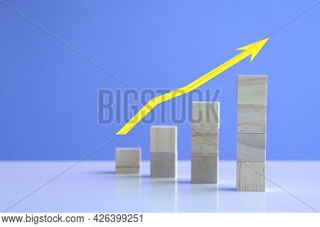 Uptrend With Yellow Arrow Up From Stacked Wooden Cubes. Concept For Bullish Market And Growth.
