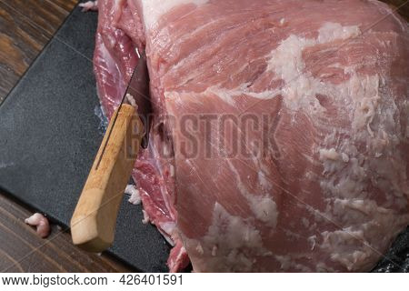 Slice The Pork Or Beef With A Knife On The Table In Close-up.preparation Of Meat Dishes And Food Pro