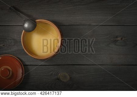 Pure Or Desi Ghee Also Known As Clarified Liquid Butter. Pure Or Desi Ghee In Ceramic Bowls On An Ol