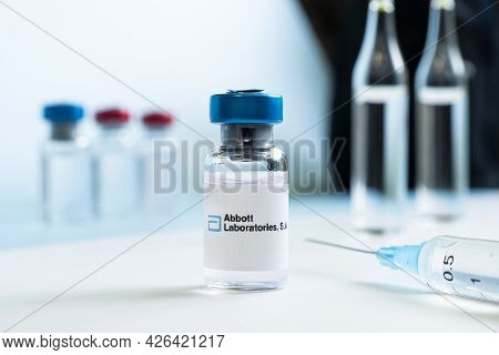 Vials Of Liquid On A White Table And The Logo Abbott Laboratories, Large Pharmaceutical Company. Mar