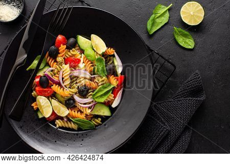 Whole Grain Pasta With Vegetables On A White Plate On Black Slate, Stone Or Concrete Background. Top