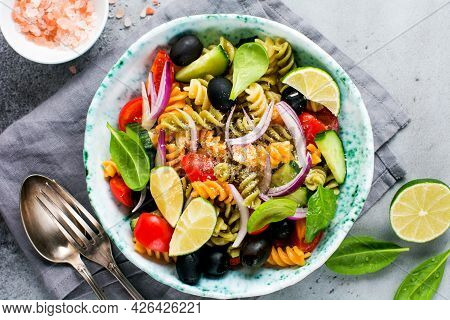Whole Grain Pasta With Vegetables On A White Plate On A Light Grey Slate, Stone Or Concrete Backgrou