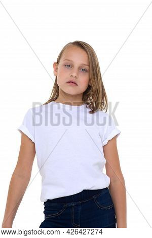 Blonde In A White T-shirt. Pretty Stylish Girl Posing In Studio On A White Background. Close-up Port