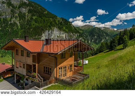 Summer Valley With Grossarler Ache Small River And Blue Cloudy Sky