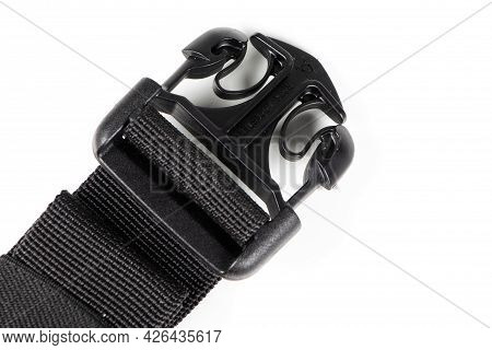 Black Plastic Fastex Clip For Backpacks On A White Background. Items Of Clothing And Equipment.