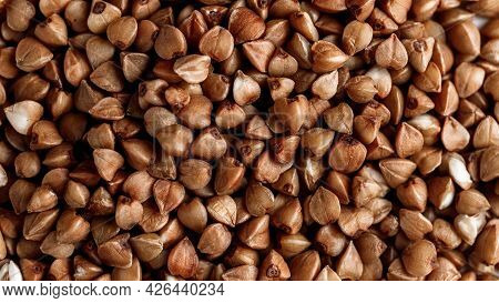 Macro Photo Of Buckwheat Groats. Many Small Objects Close Up. Healthly Food