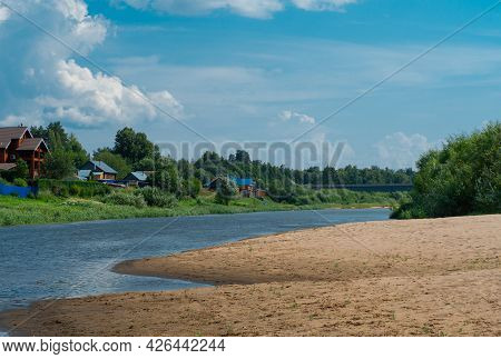 Beautiful Landscape View With A Village On The Bank Of A Forest River In Summer Sunny Day.
Wide Dist