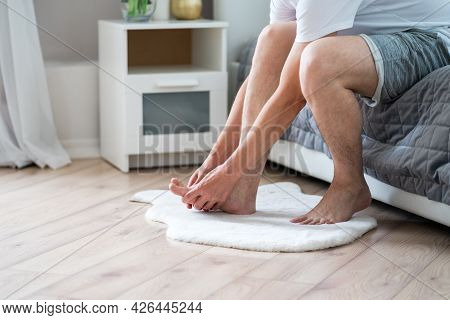 Foot Pain, Man Suffering From Feet Ache In Home Interior