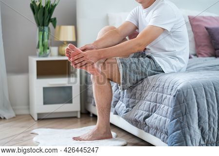 Foot Pain, Man Suffering From Feet Ache In Home Interior