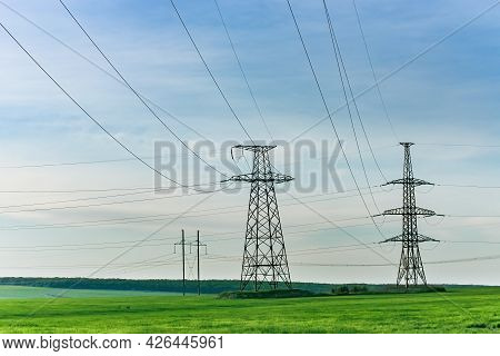 High Voltage Electric Pylon And Electrical Wire At Green Field. Electricity Pylon And High Voltage G