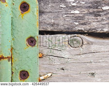 Fragment Of A Rustic Gate In A Fence Close-up. Old Gray Weathered Wooden Beams And Door Hinge. Vinta