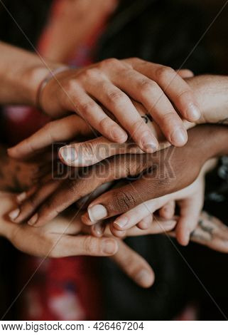 Creative team stacking their hands