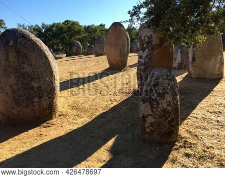 Dramatic Image Of Neolithic Monument In Golden Hour Sunlight, Casting Planned, Long Shadows Across T