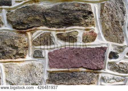 Pennsylvania Farmhouse Red Stone Wall Background. Vibrant Colors And Masonry Texture, Solid Sturdy A