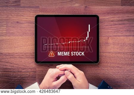 Meme Stock Investment Warning Concept With Digital Tablet. Soaring Graph Of Stock Or Cryptocurrency 