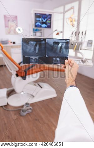 Specialist Radiologist Holding Medical Teeth Radiography In Hands Examining Teethcare Surgery Expert