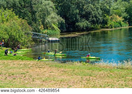 Miravet, Spain - June 12.2021: Kayaks At The Ebro River Passing Through Miravet, Spain