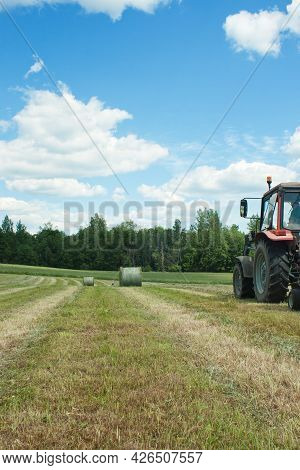 Farmland During Harvesting And Making Hay Bales For Livestock