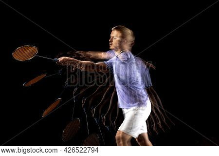 Portrait Of Young Man, Male Badminton Player, Shuttler In Motion And Action On Dark Background. Stro