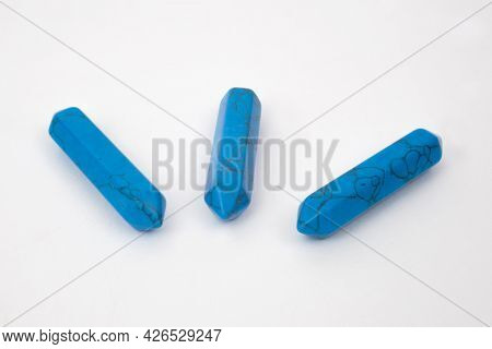 Blue Turquoise Points, Gemstones Used For Healing Photographed Against A White Background