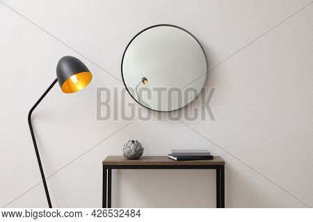 Console Table And Lamp Near Light Wall With Mirror Indoors. Interior Design