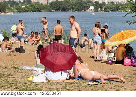 Moscow, Russia - July 2021: People Tanning On A Beach Of Moscow River In Strogino. Hot Weather, Summ