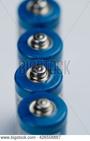 Macro Photo Of Batteries For Electronic Devices On A White Background.
