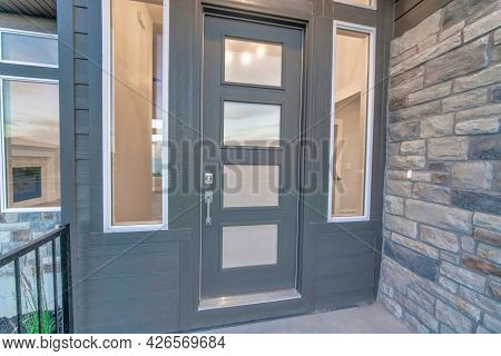 Frosted Glass Panels On The Gray Front Door Of House With With Clear Sidelights