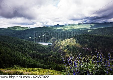 Mountain Lake Uchkel Is Surrounded By Mountains And Coniferous Taiga. Ulagan District Of The Altai R