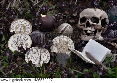 Grunge Still Life Wil Skull, Crystal, Burning Candle, Book And Magic Ritual Objects Outside. Esoteri