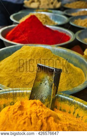 Turmeric curcuma powder and chili powder in spices market in India. Sardar Market, Jodhpur, Rajasthan, India
