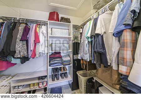 Full Small Walk In Closet With Baskets And Vault Inside