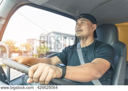 Happy Smiling Truck Driver Bearded Male Fastens His Seat Belt While Driving. Delivery Man Transport 