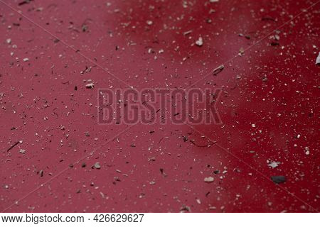 Surface Of Red Car Covered With Detritus And Ashes From A Nearby Fire