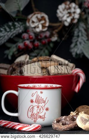 Christmas Decorations With Cookies, Candy, Toyon, Pine Cones And A Mug With The Message, Merry Chris
