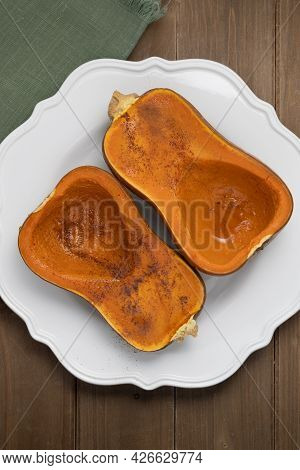One Winter Squash, Halved And Roasted, On White Plate, Vegan Dish With Cinammon And Honey, Autumn Ha