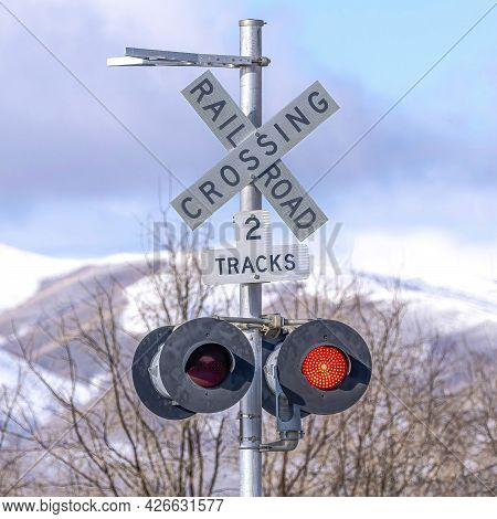 Square Grade Crossing Signal With Red Light Gate And Crossbuck At Railroad Crossing