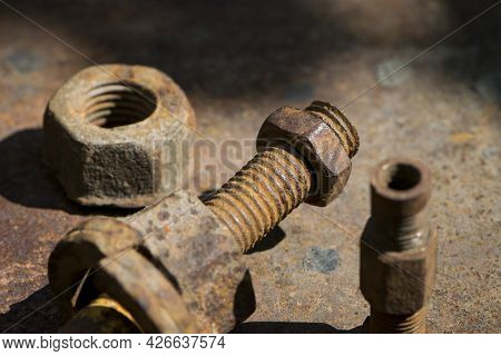 Old Rusty Bolt, Iron Rod With Screw Threads. Rusted Mechanical Components. Threaded Bolt And Nut. Di