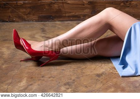 Red Stiletto Heels On The Legs Of A Girl