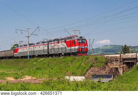 Krasnoyarsk, Russia - June 20, 2021: Red And Grey Freight Train Or Locomotive With Of Rzhd Logo On T