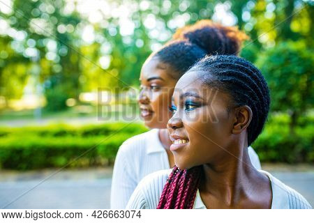 Brazilian Lesbian Couple In White Dress Spending Time Together Celebrating Engagement In Summer Park