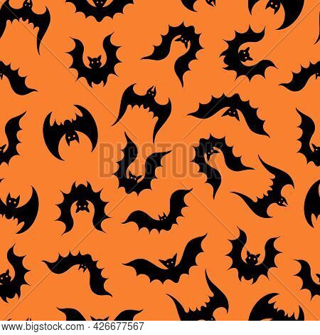 Bats Vector Seamless Pattern. A Flock Of Flying Predators On An Orange Background. Black Silhouettes