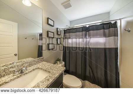 Bathroom Interior With Decorative Frames And Vanity