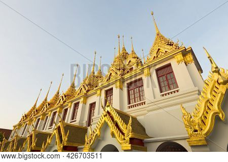 Loha Prasat At Wat Ratchanatda Temple With Blue Sky In Bangkok, Thailand.